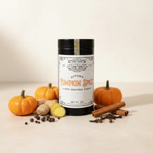 Load image into Gallery viewer, tin of pumpkin spice tea on a white background with pumpkins, cinnamon, ginger, and cloves.