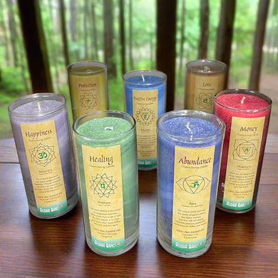 Set of colorful candles with labels on a wooden shelf