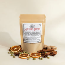 Load image into Gallery viewer, A stand-up kraft paper pouch labeled 'Mulling Spices' with a white vintage-style label, photographed on a white display counter .
