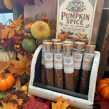 Load image into Gallery viewer, Several glass jars of Apothecary Pumpkin Spice blends arranged in a white wooden carrier, with the main product box standing behind them and autumn-themed decor visible on the left.
